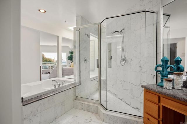 a bathroom with a granite countertop shower a mirror and a sink