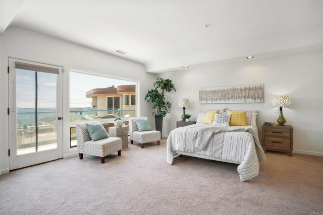 a spacious bedroom with a bed and wooden floor