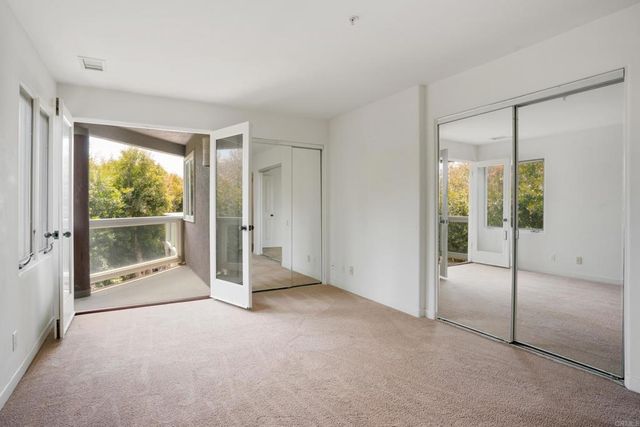 a view of an empty room with sliding glass door