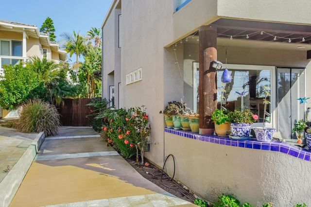 a view of a house with potted plants