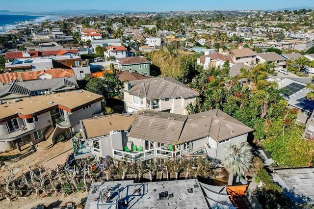 an aerial view of a house with a yard basket ball court and outdoor seating