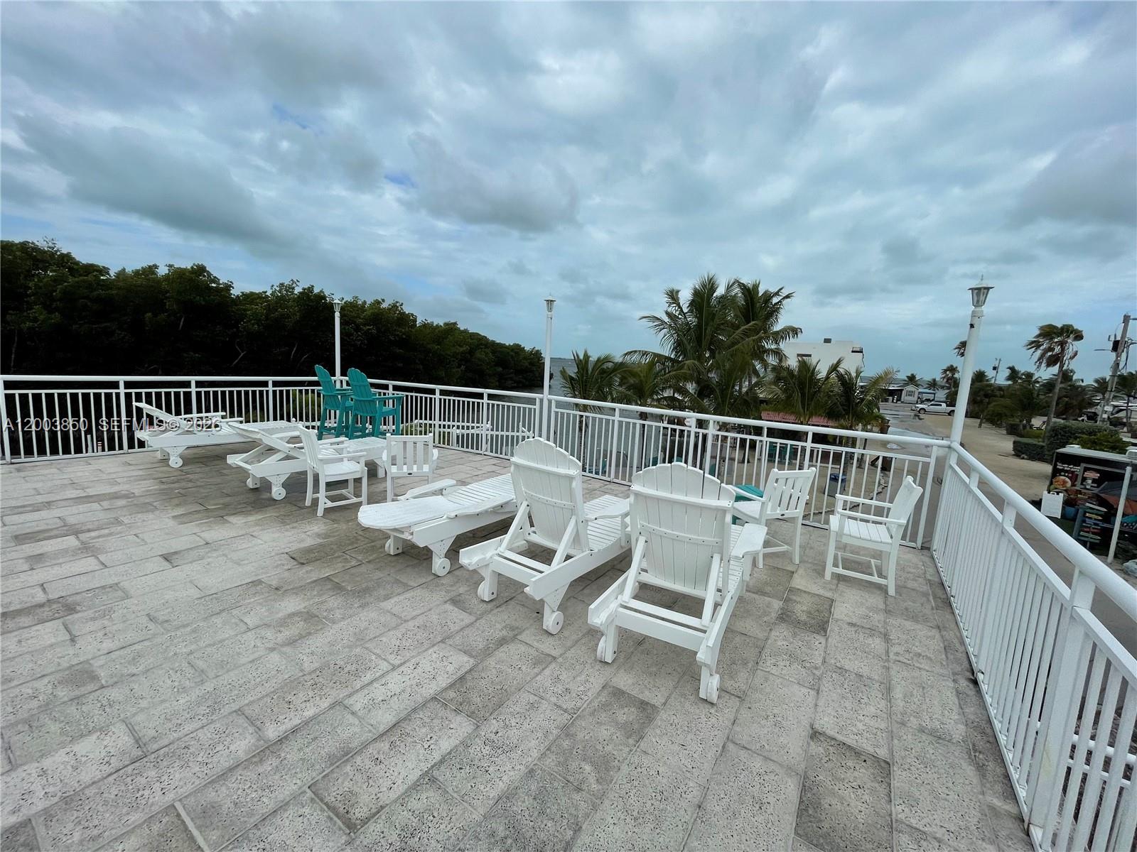 325 Calusa Street Key Largo, FL 33037 - Photo 14 of 19 a view of a terrace with chairs