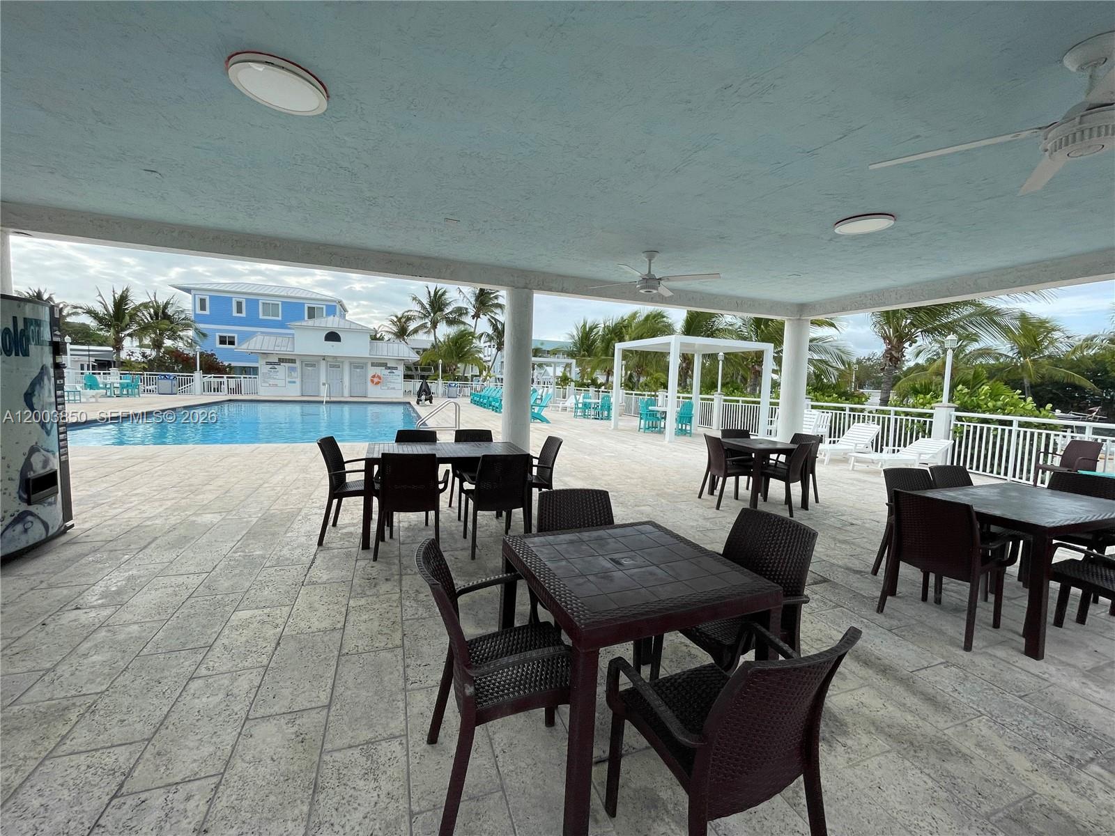 325 Calusa Street Key Largo, FL 33037 - Photo 15 of 19 a view of a dining room with furniture window and outside view