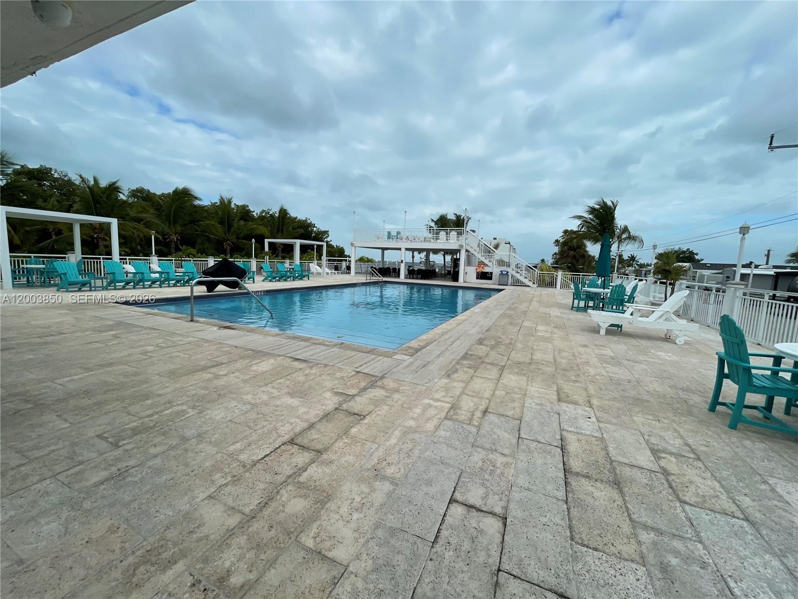 325 Calusa Street Key Largo, FL 33037 - Photo 17 of 19 a view of a swimming pool with lawn chairs