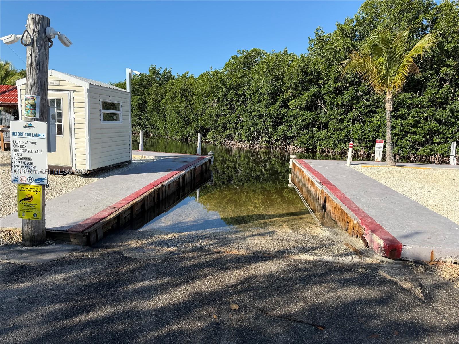 325 Calusa Street Key Largo, FL 33037 - Photo 18 of 19 a view of a backyard with chairs