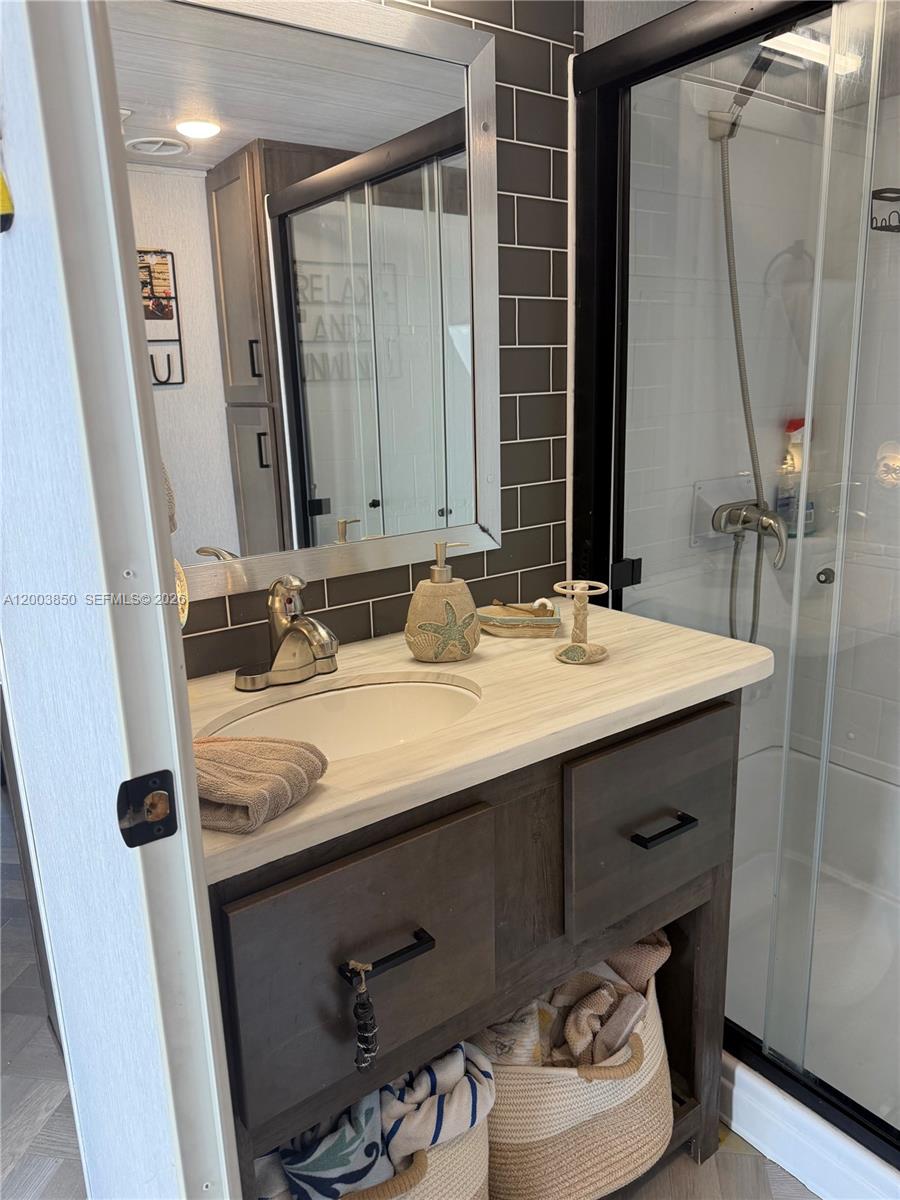 325 Calusa Street Key Largo, FL 33037 - Photo 3 of 19 a bathroom with a sink vanity and a mirror