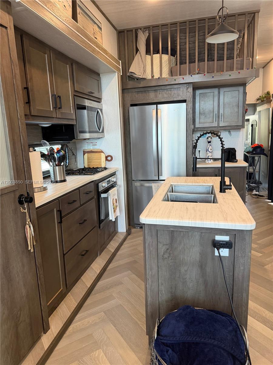 325 Calusa Street Key Largo, FL 33037 - Photo 5 of 19 a kitchen with kitchen island a stove a sink and a refrigerator