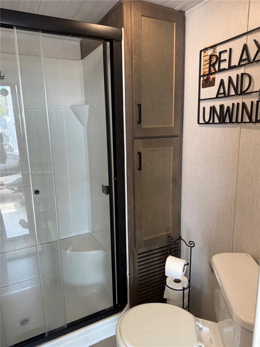325 Calusa Street Key Largo, FL 33037 - Photo 9 of 19 a white toilet sitting next to a bathroom sink