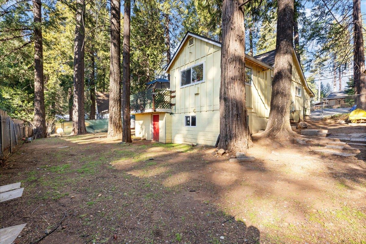 6780 Ridgeway Drive Pollock Pines, CA 95726 - Photo 26 of 27 a view of a white house next to a road and trees