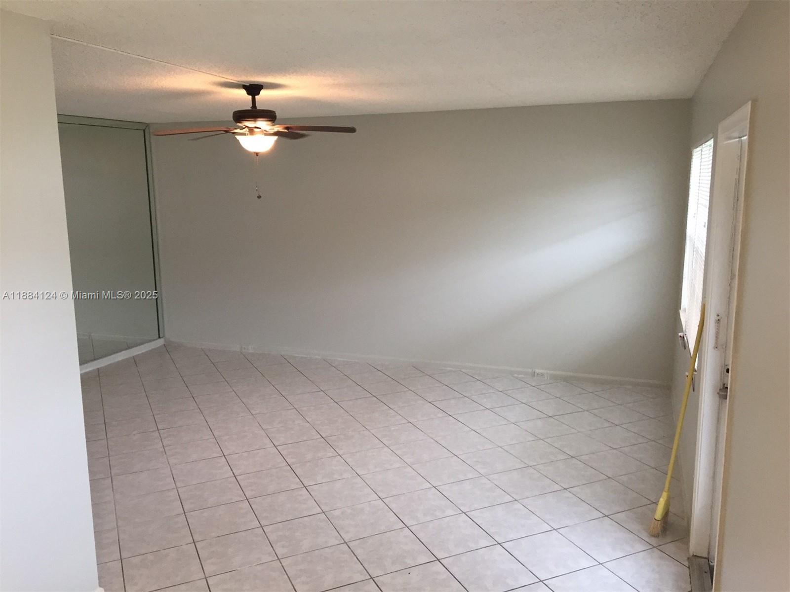 182 Markham I, Unit 182 Deerfield Beach, FL 33442 - Photo 3 of 7 an empty room with chandelier fan