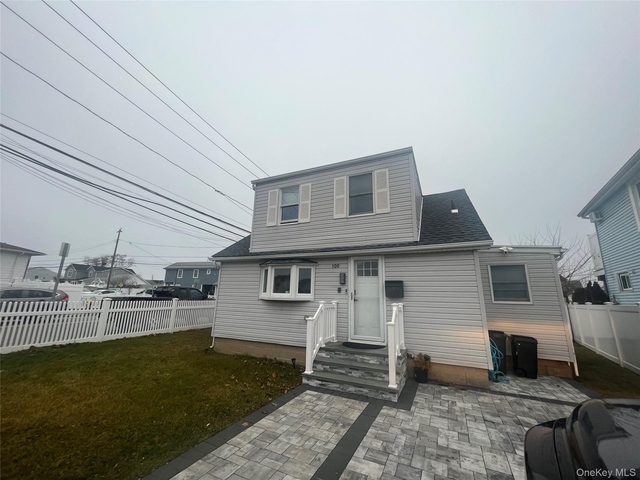 100 Clubhouse Road Bellmore, NY 11710 - Photo 1 of 18 View of front of property with a patio and a shingled roof