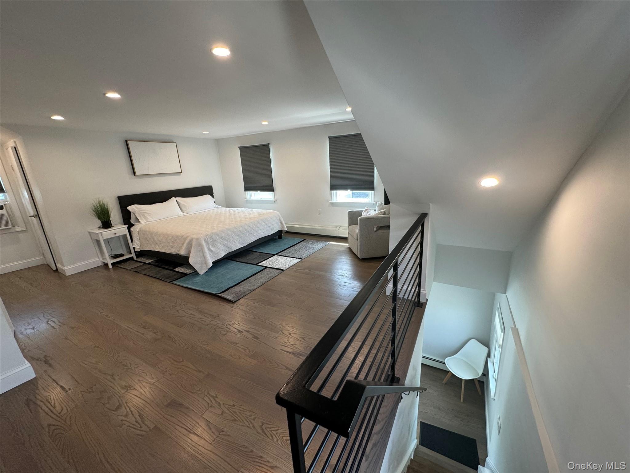 100 Clubhouse Road Bellmore, NY 11710 - Photo 15 of 18 Bedroom with recessed lighting, dark wood-style flooring, and baseboard heating