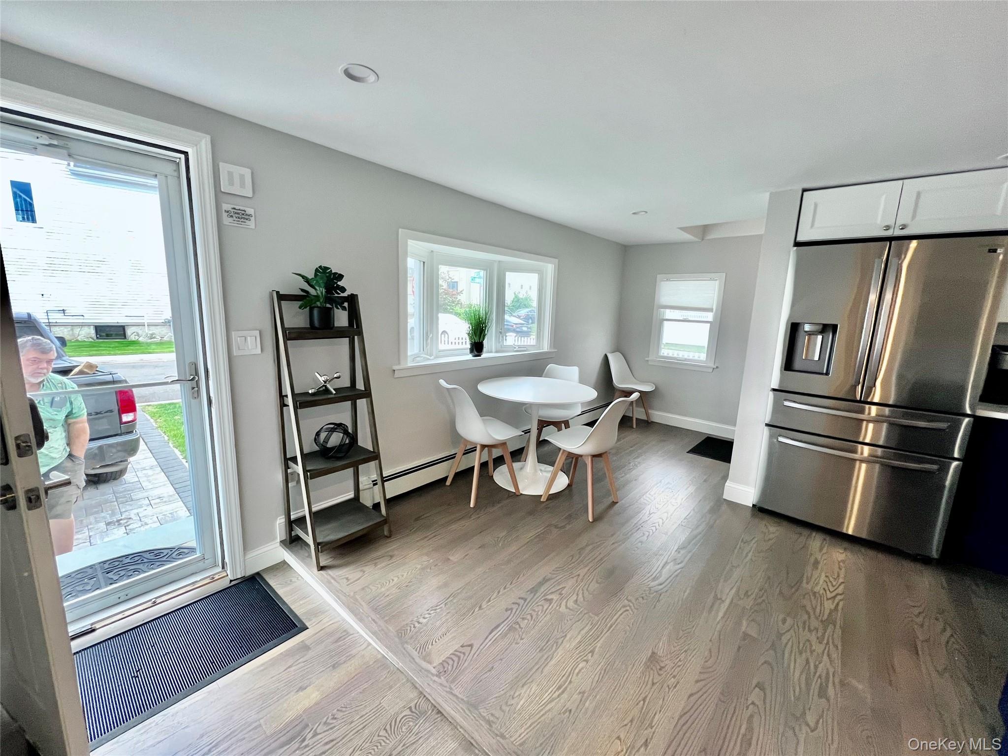 100 Clubhouse Road Bellmore, NY 11710 - Photo 5 of 18 Dining area featuring light wood finished floors and baseboards