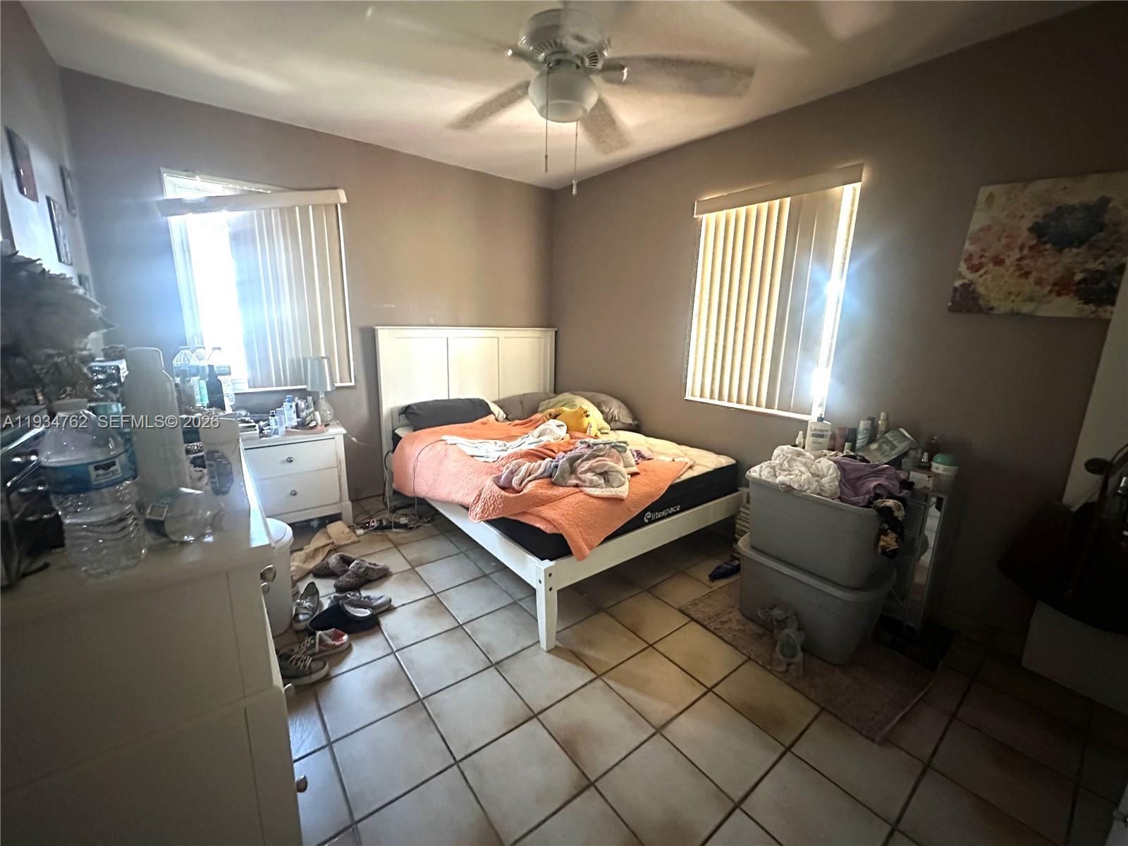 4361 Southwest 3rd Street Miami, FL 33134 - Photo 12 of 24 a bedroom with a bed and a chandelier