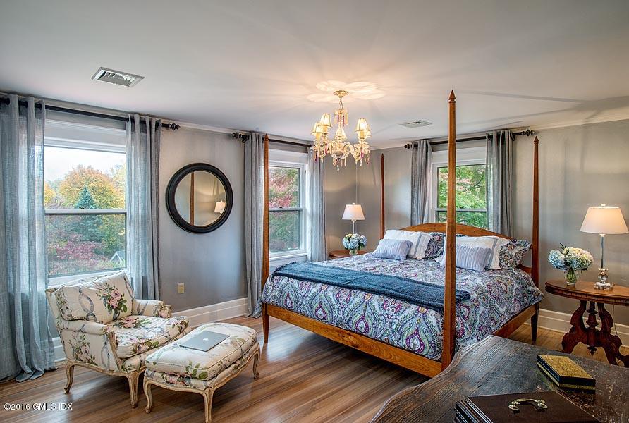 45 Sinawoy Road Cos Cob, CT 06807 - Photo 12 of 18 a bedroom with a bed a chandelier and dresser
