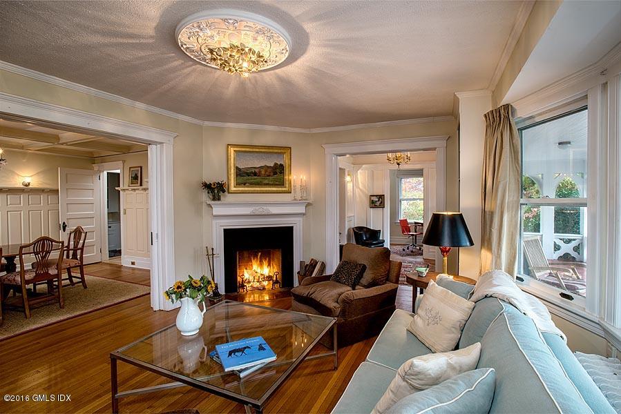 45 Sinawoy Road Cos Cob, CT 06807 - Photo 8 of 18 a living room with furniture a fireplace and a large window