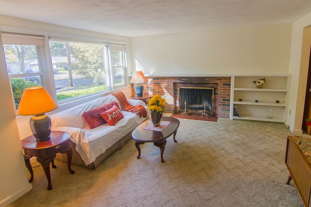 13 Wethersfield Road Natick, MA 01760 - Photo 2 of 11 a living room with furniture lamp and a fireplace