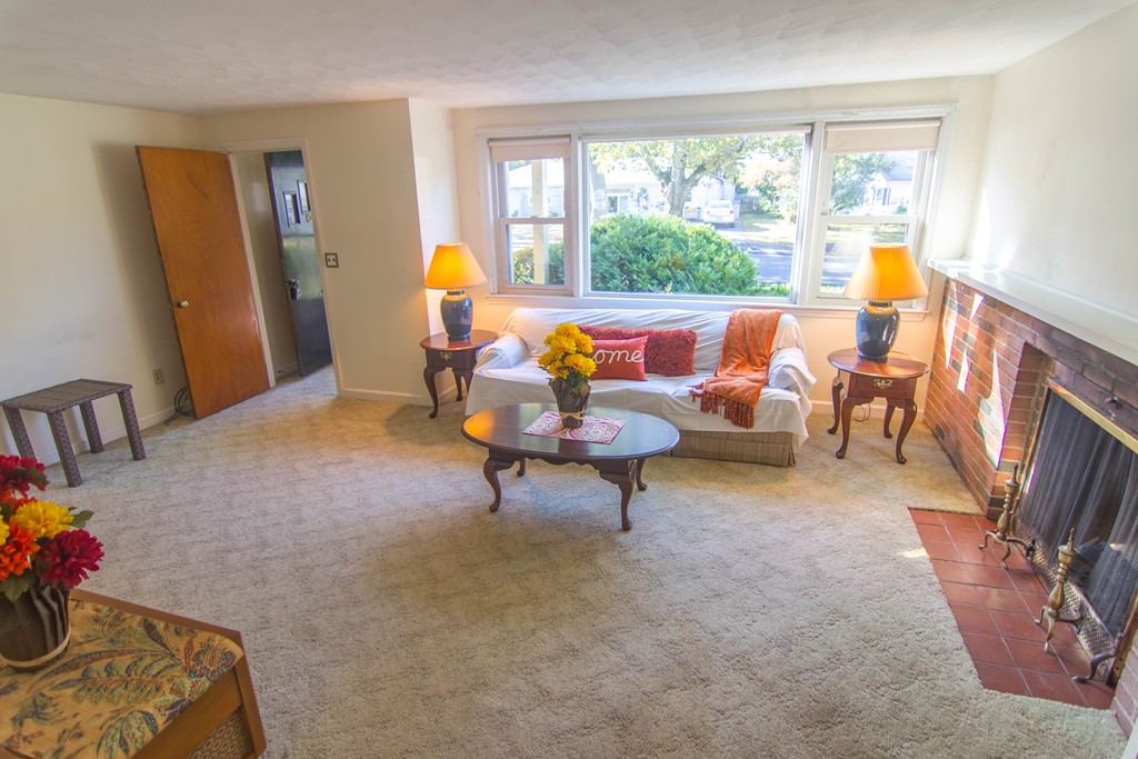 13 Wethersfield Road Natick, MA 01760 - Photo 3 of 11 a living room with furniture and a fireplace