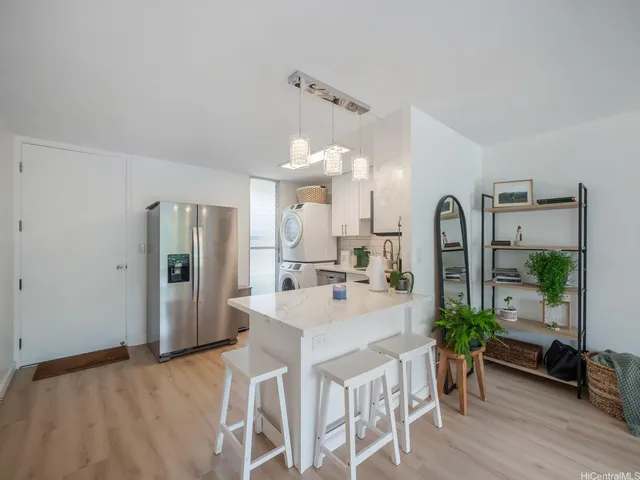 a large white kitchen with a large window