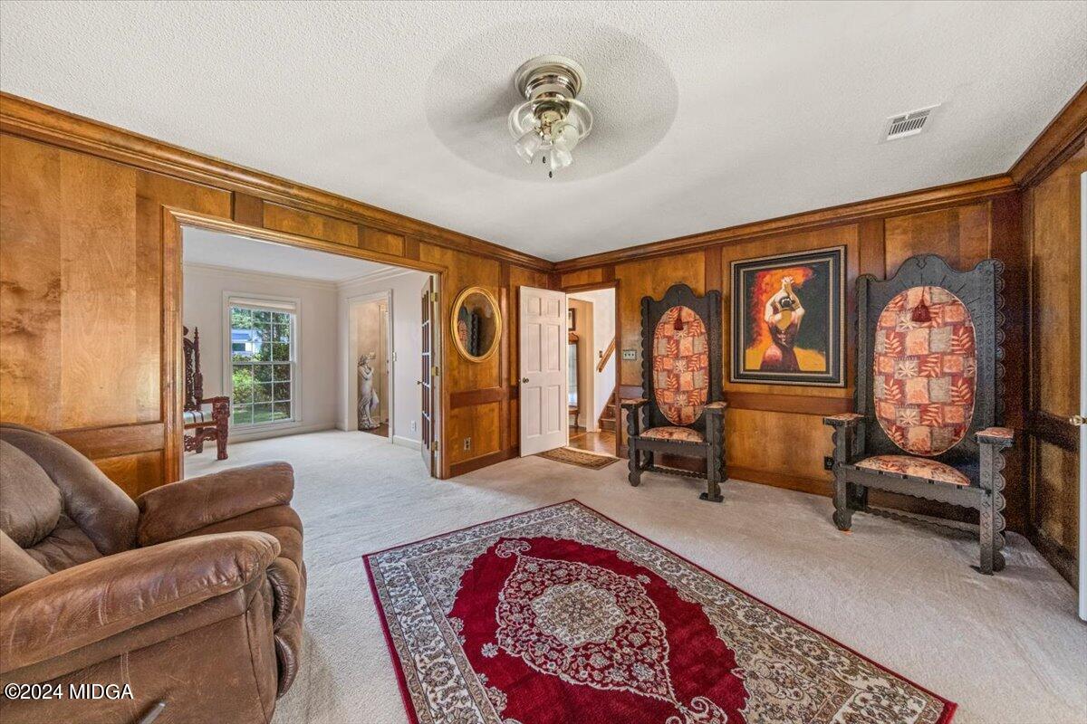 5369 Rivoli Drive Macon, GA 31210 - Photo 18 of 40 a living room with furniture a rug and a chandelier