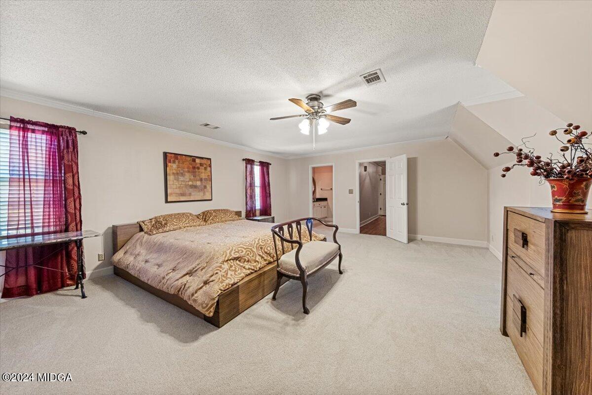 5369 Rivoli Drive Macon, GA 31210 - Photo 31 of 40 a spacious bedroom with a bed painting on wall and a window