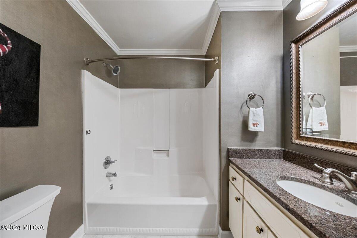 5369 Rivoli Drive Macon, GA 31210 - Photo 34 of 40 a bathroom with a granite countertop sink and a mirror