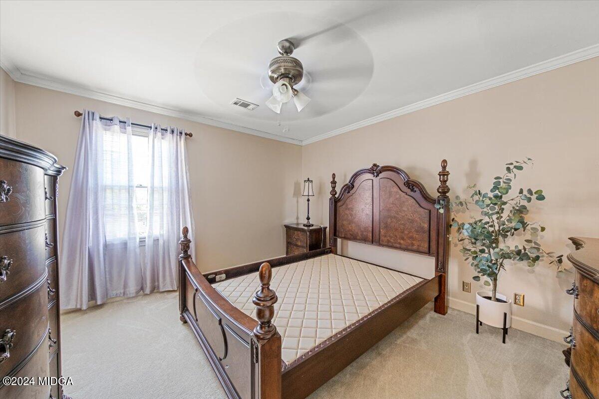 5369 Rivoli Drive Macon, GA 31210 - Photo 37 of 40 a bedroom with a bed and a chandelier