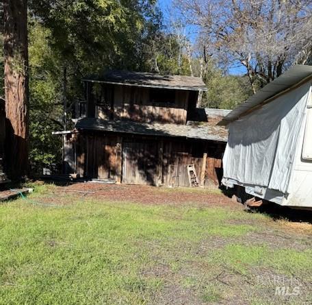 14180 Poonkinney Road Dos Rios, CA 95429 - Photo 13 of 18 a view of a small house with yard and sitting area