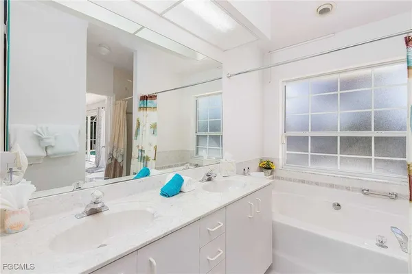 a bedroom with a large bed and a potted plant