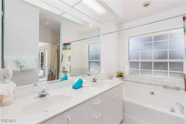 a bedroom with a large bed and a potted plant