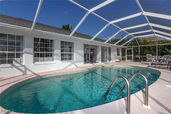 a kitchen with stainless steel appliances a table and chairs in it