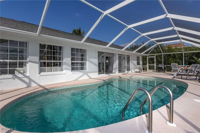 a kitchen with stainless steel appliances a table and chairs in it