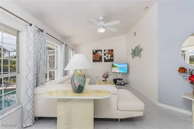 a room with pool table and windows