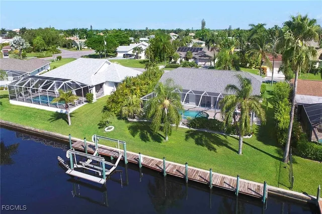 an aerial view of a house with a garden and a yard