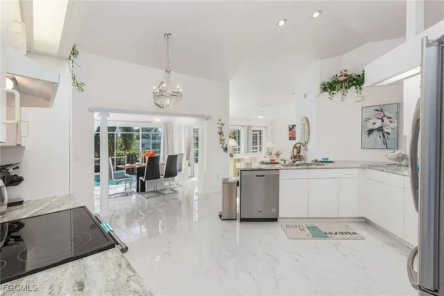 a dining room with furniture a livingroom and chandelier