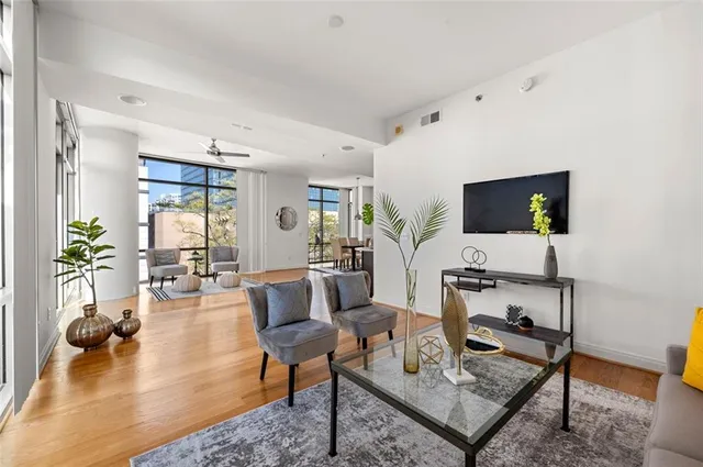 a living room with furniture a rug and a flat screen tv