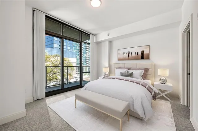 a bedroom with a large bed and a large window