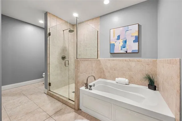 a bathroom with a bathtub and a shower