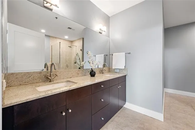 a bathroom with a double vanity sink and a mirror