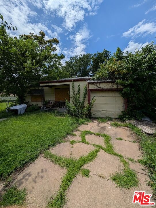 1231 Mathewson Street Wichita, KS 67214 - Photo 2 of 5 a view of a pathway with a yard