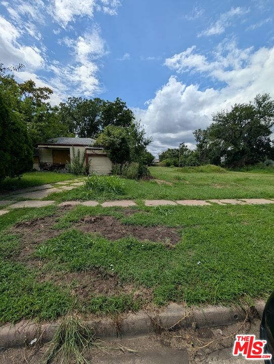 1231 Mathewson Street Wichita, KS 67214 - Photo 3 of 5 a front view of a house with a yard