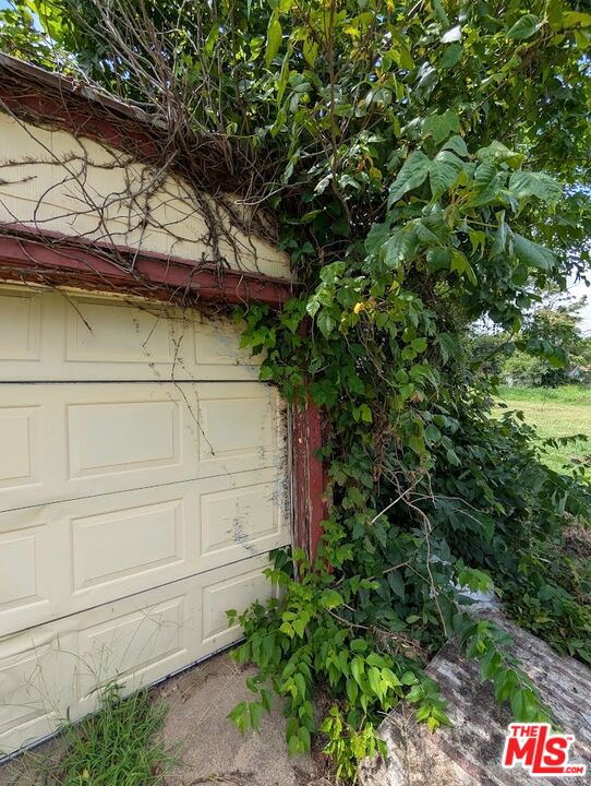 1231 Mathewson Street Wichita, KS 67214 - Photo 5 of 5 a view of a wooden house with a tree