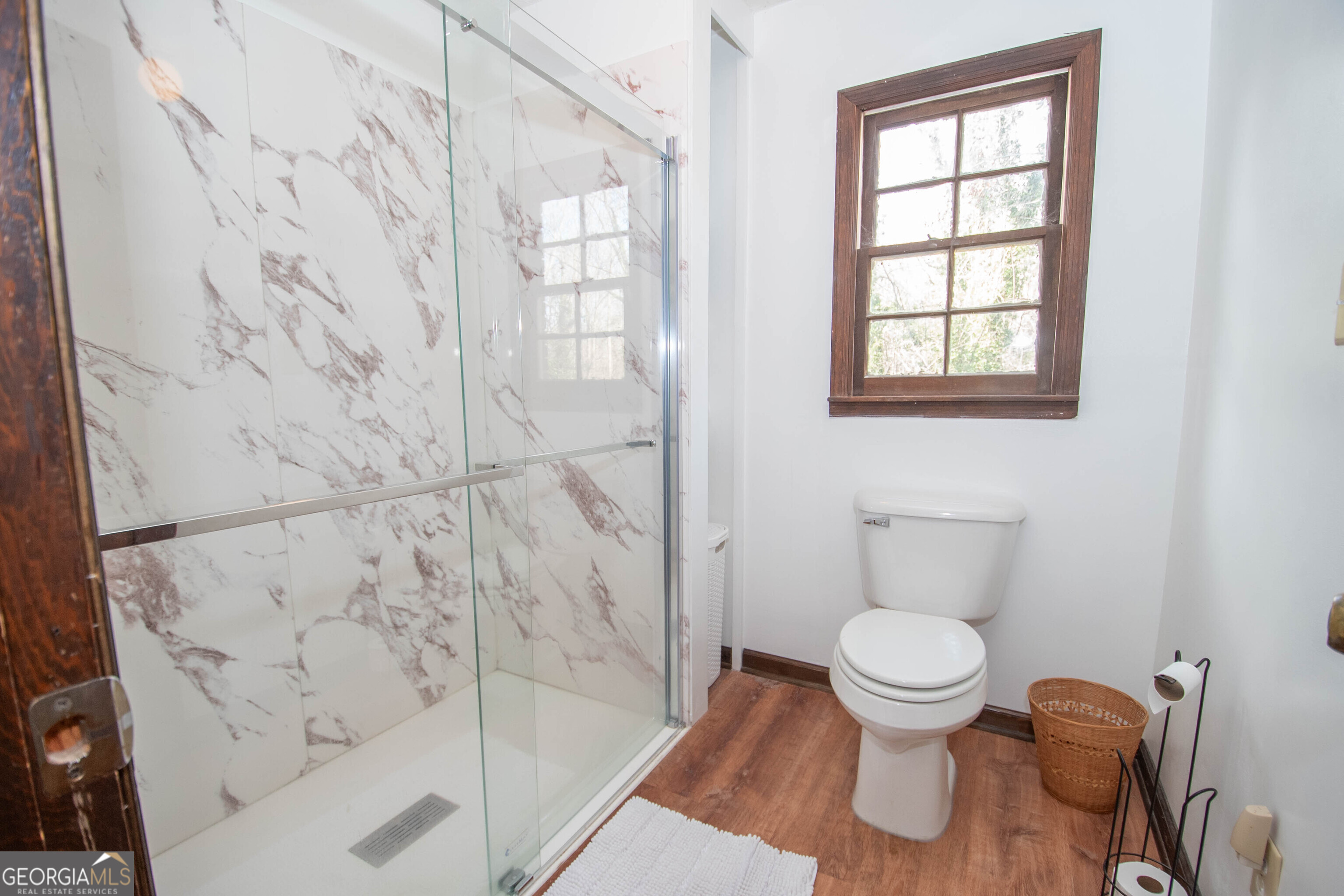 151 Evans Road Milner, GA 30257 - Photo 16 of 53 a bathroom with a toilet and a shower curtain