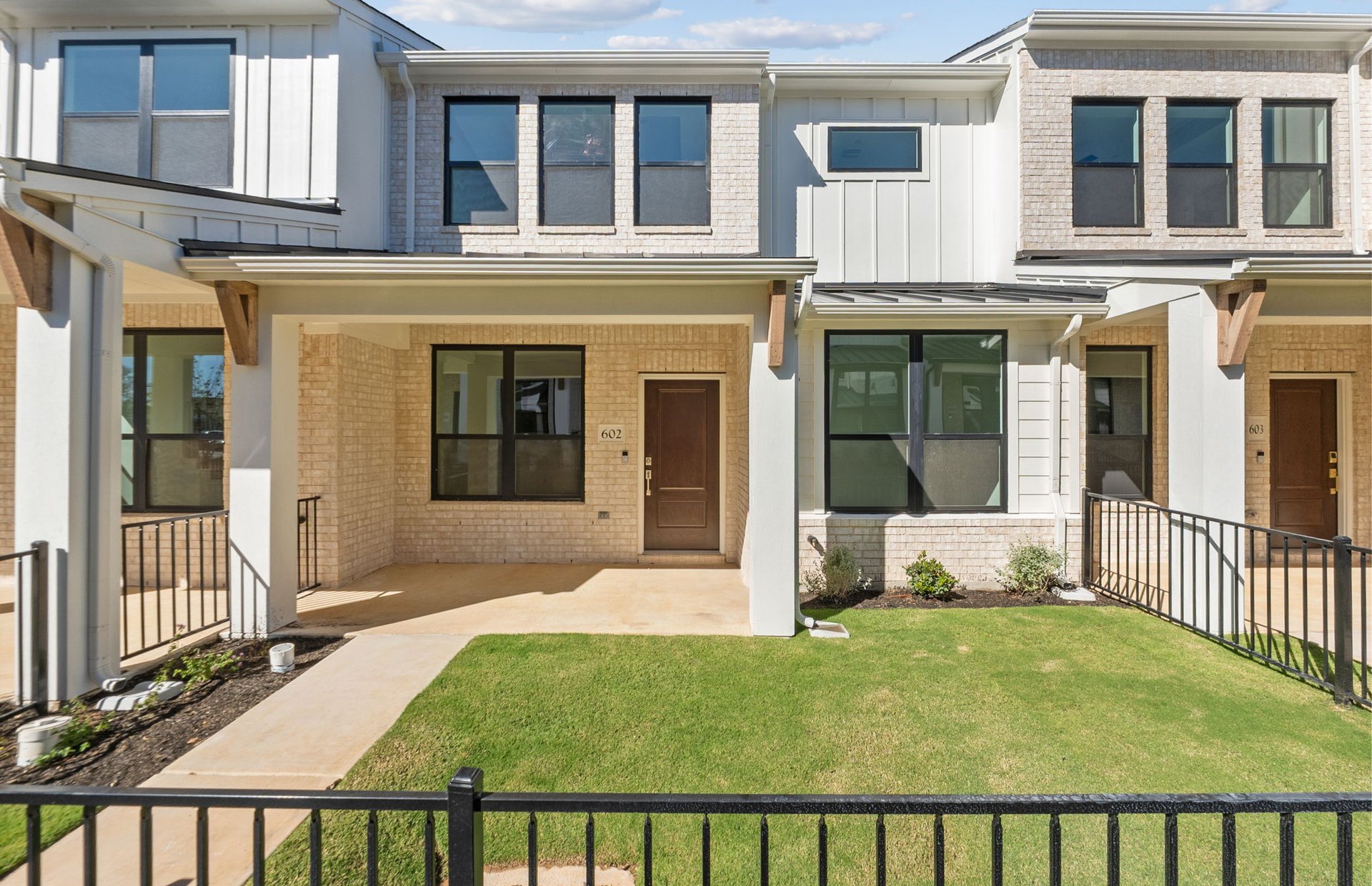 1280 East Main Street, Unit 602 Round Rock, TX 78664 - Photo 1 of 22 a front view of a house with a yard