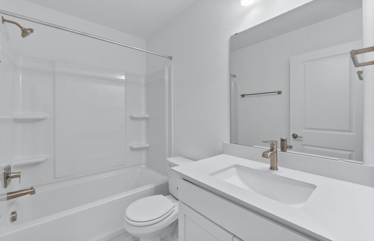 1280 East Main Street, Unit 602 Round Rock, TX 78664 - Photo 15 of 22 a bathroom with a sink a toilet and a bathtub