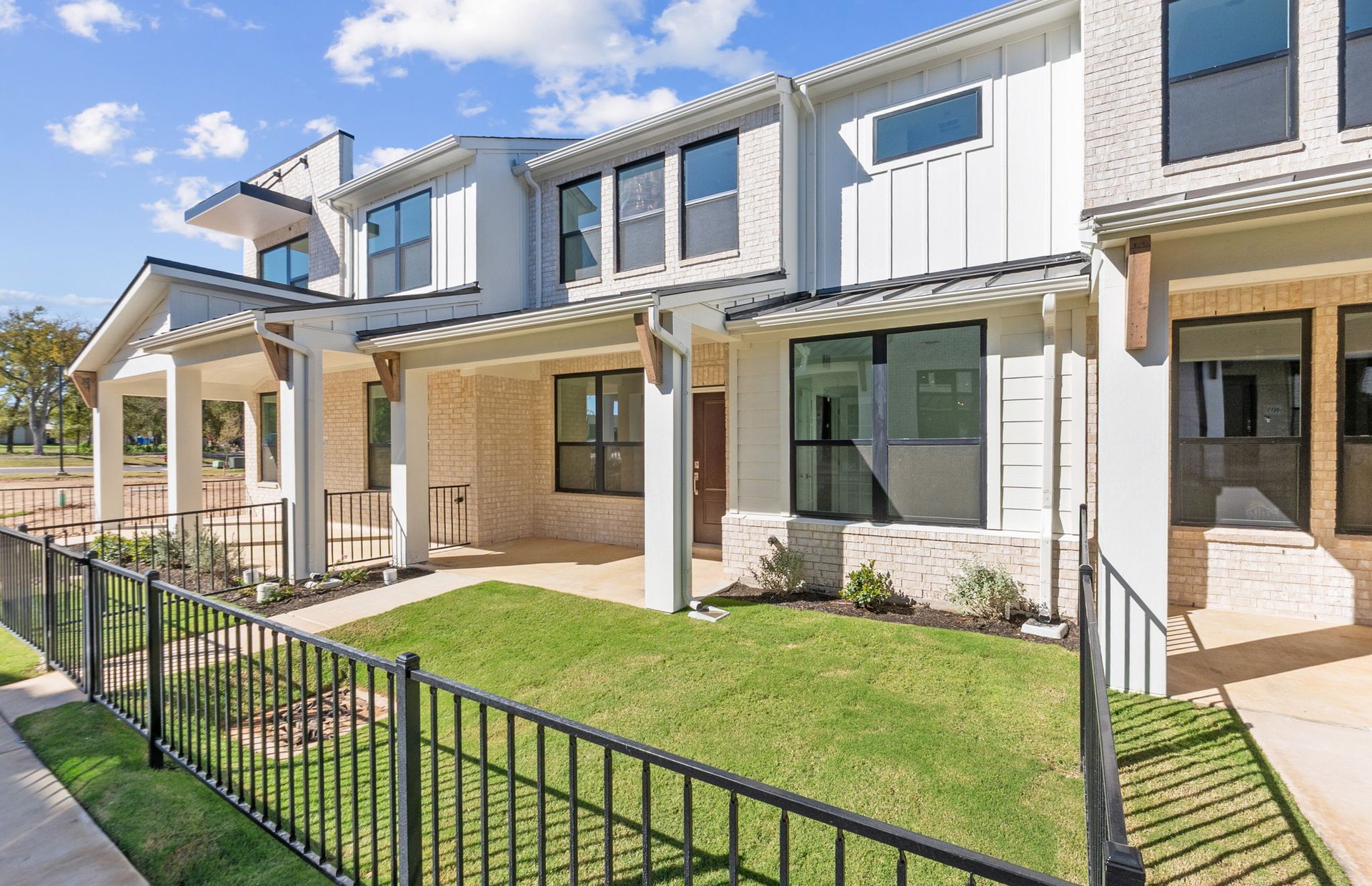 1280 East Main Street, Unit 602 Round Rock, TX 78664 - Photo 2 of 22 a front view of a house with a yard