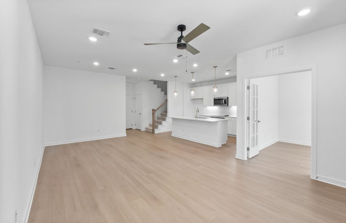 1280 East Main Street, Unit 602 Round Rock, TX 78664 - Photo 5 of 22 a view of a kitchen with a sink and a refrigerator