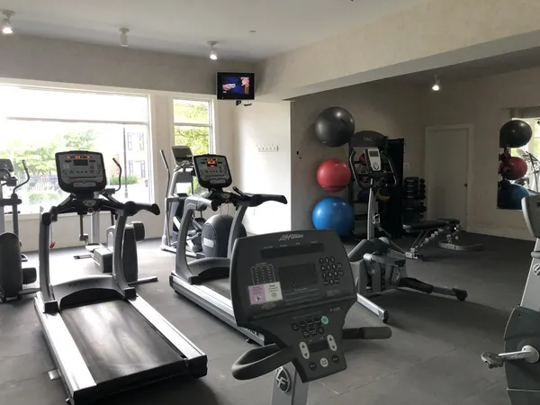 a room with gym equipment and a large window
