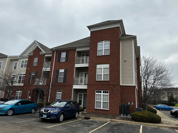 a car parked in front of a brick house