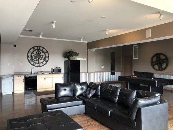 a living room with furniture and a clock